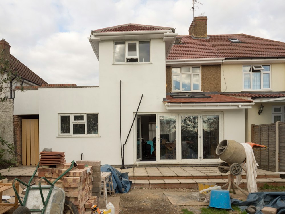 House extension under construction with building materials outside